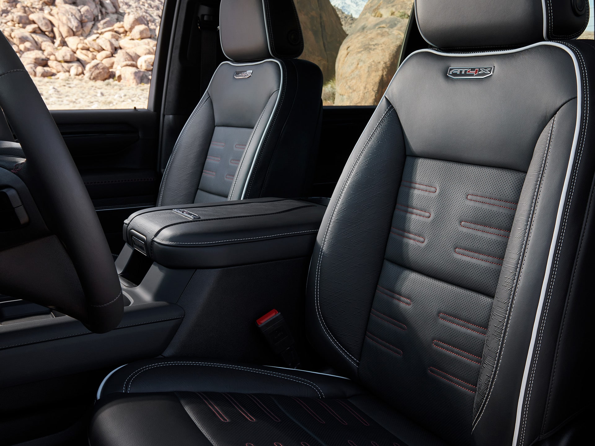 Interior View of the Front Row Seats in the 2026 GMC Sierra HD AT4X Heavy Duty Truck.