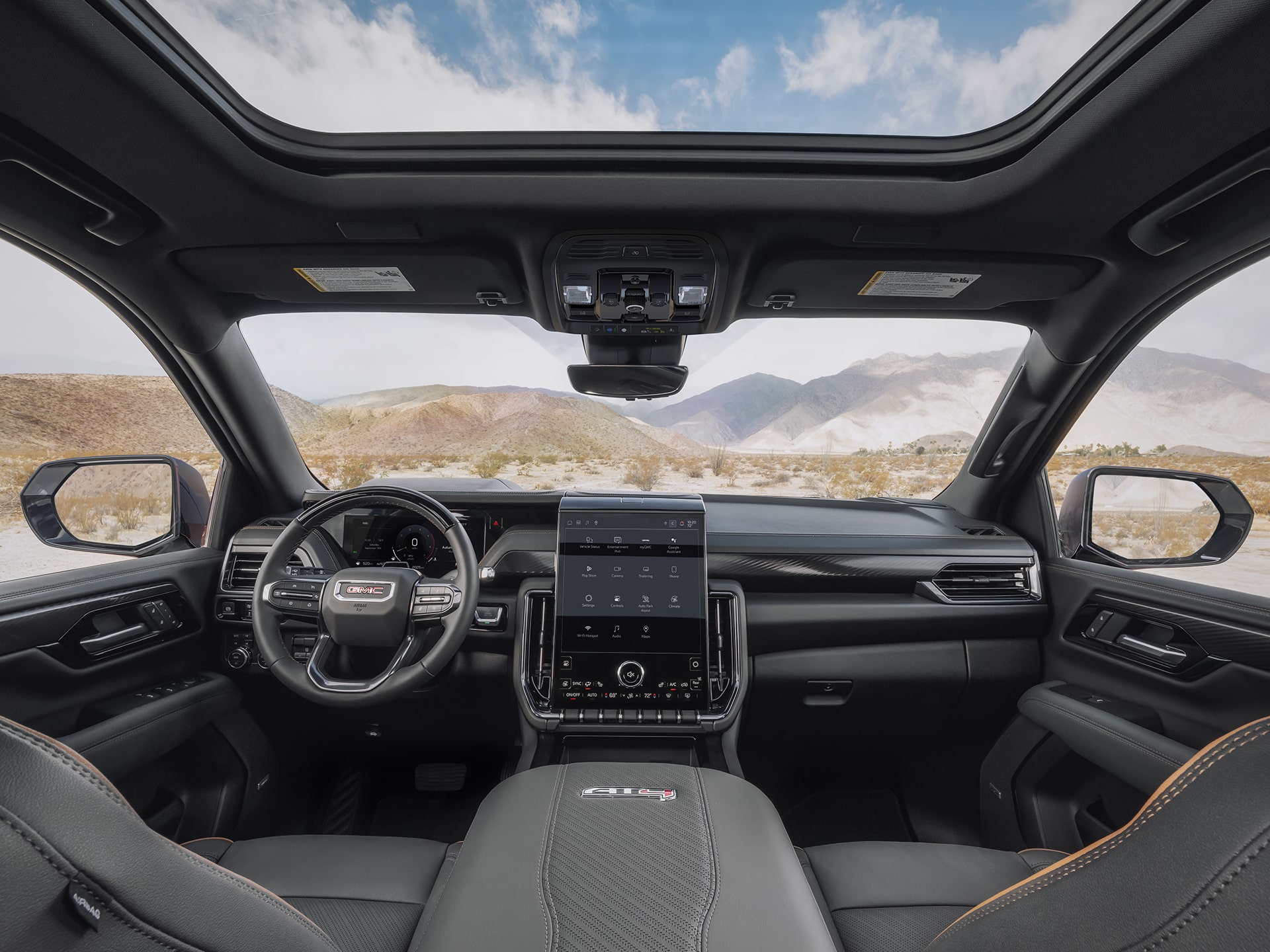 Interior View of the Front Row Seats and Dashboard in the 2026 GMC Yukon AT4 Full-Size Off-Road SUV.