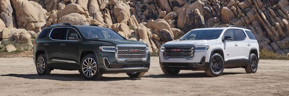 2022 GMC Acadia Denali and AT4 parked outdoors.