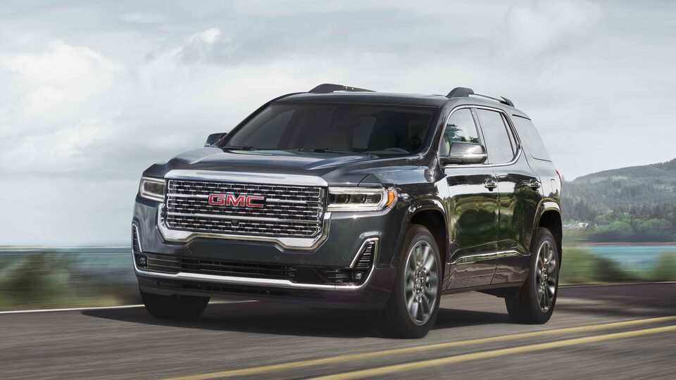 2022 Acadia Denali driving on the road.