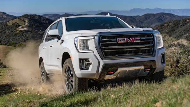 2023 GMC Yukon AT4 driving off-road.