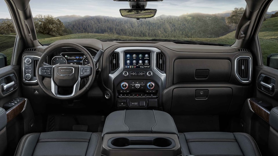 2023 Sierra HD Denali premium interior dashboard featuring the steering wheel and infotainment system.