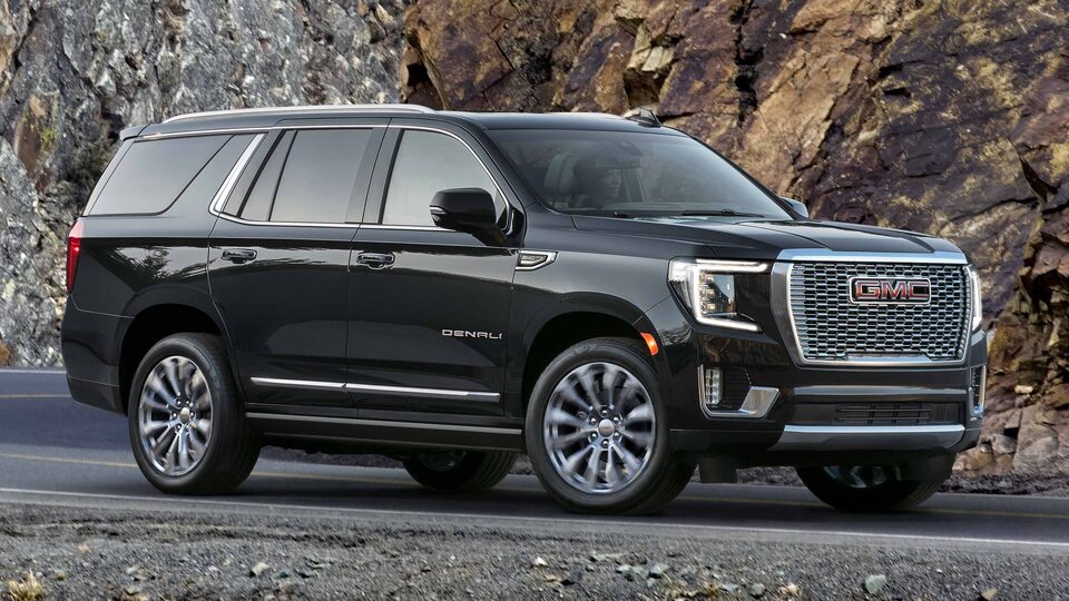Scenic shot of 2023 GMC Yukon Denali Ultimate parked on a mountain road.