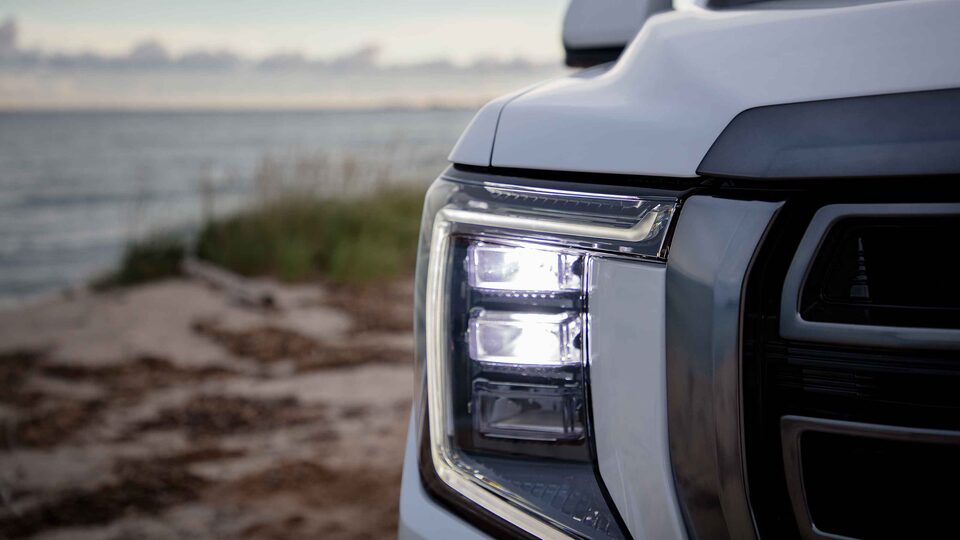 2023 GMC Yukon close-up view of front headlamps.