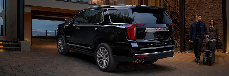 Rear view of the 2023 GMC Yukon parked.