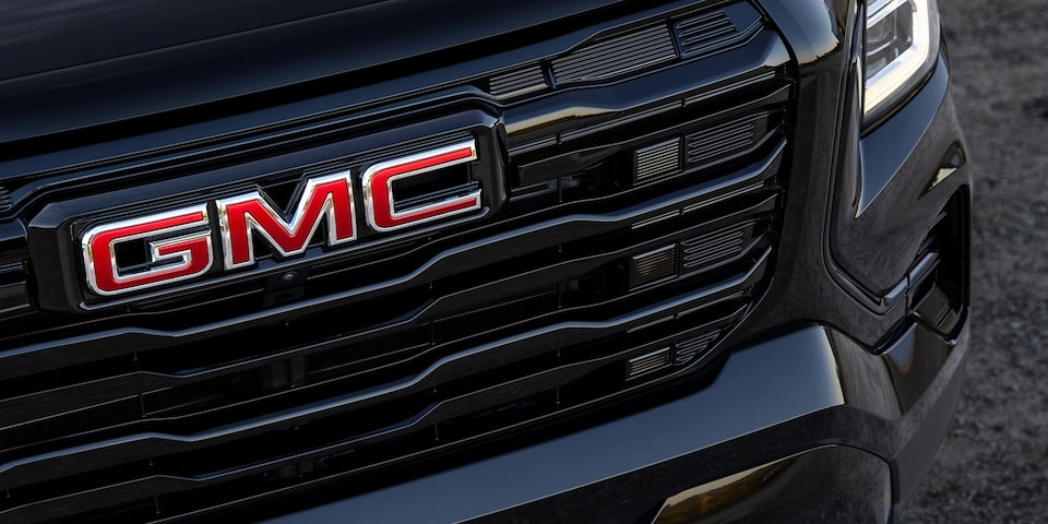 Front view of the GMC logo etched on the grille of the 2025 GMC Terrain.
