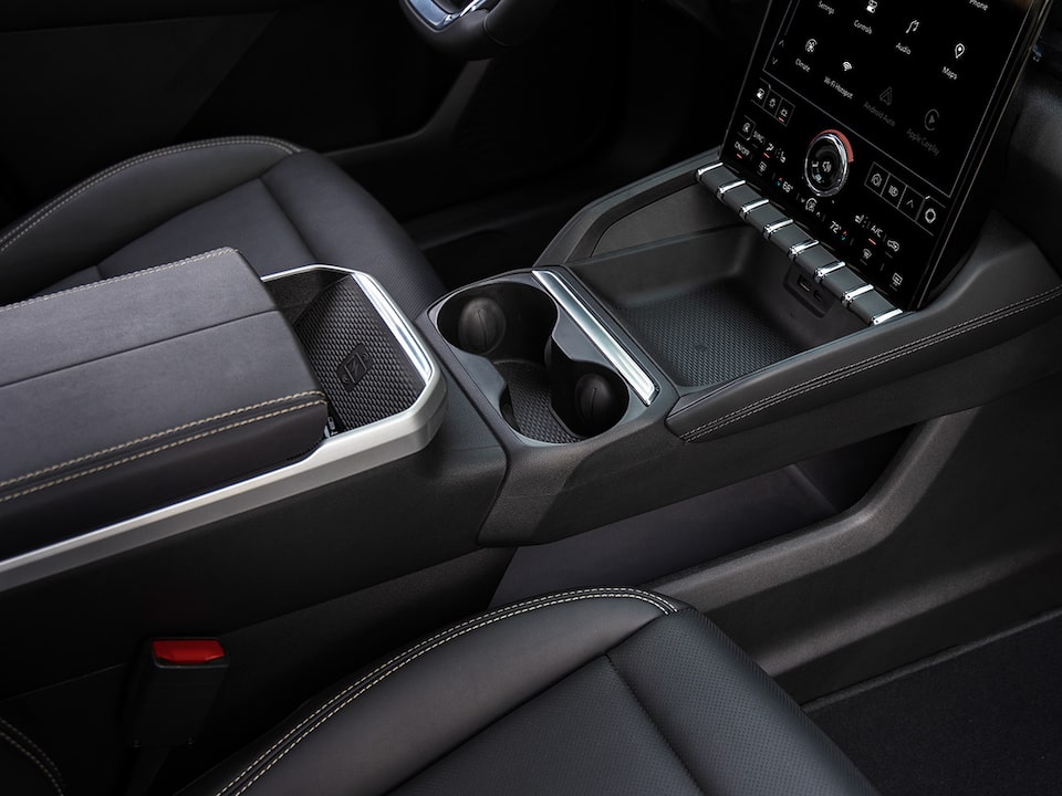Front passenger's view of the storage compartment below the center console of the 2025 Terrain.