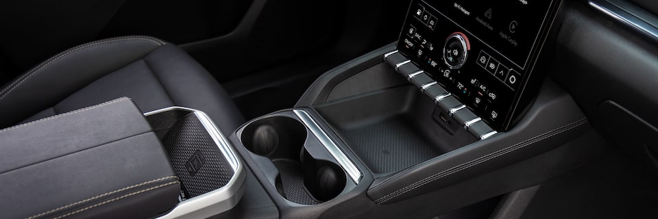 Front passenger's view of the storage compartment below the center console of the 2025 GMC Terrain.