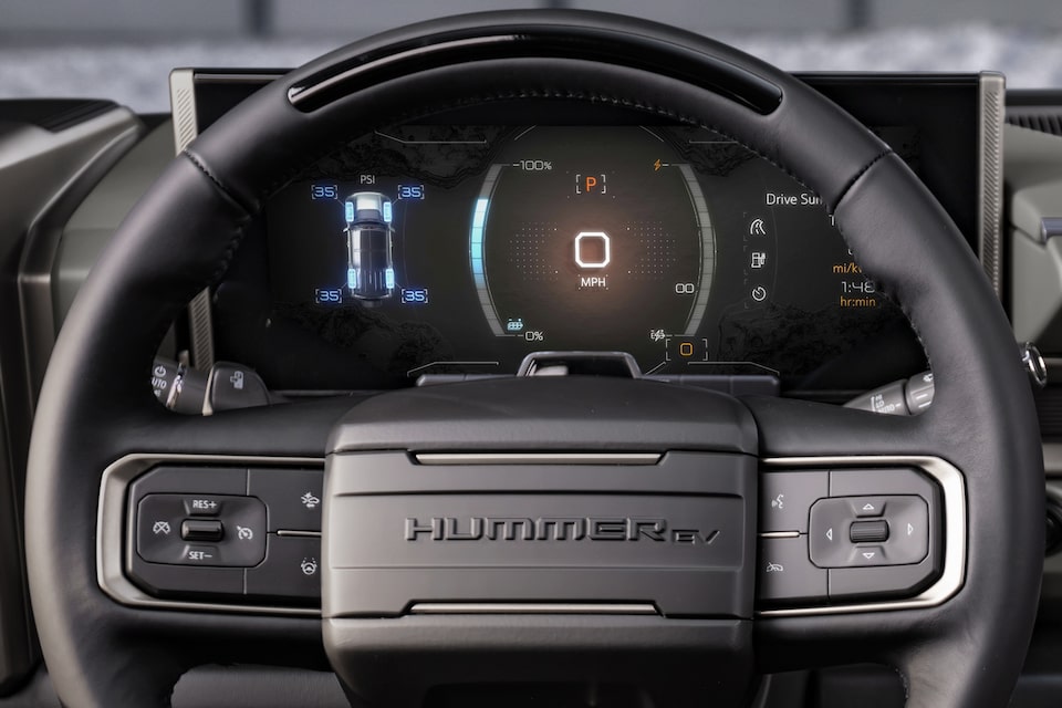 Steering wheel and dashboard of the GMC Hummer EV SUV: Regen On Demand paddle engaged.