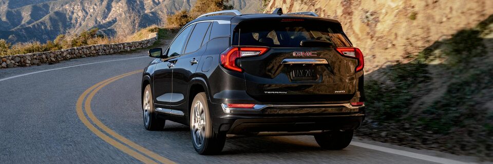 Back-view of the 2024 GMC Terrain Denali while on the road.