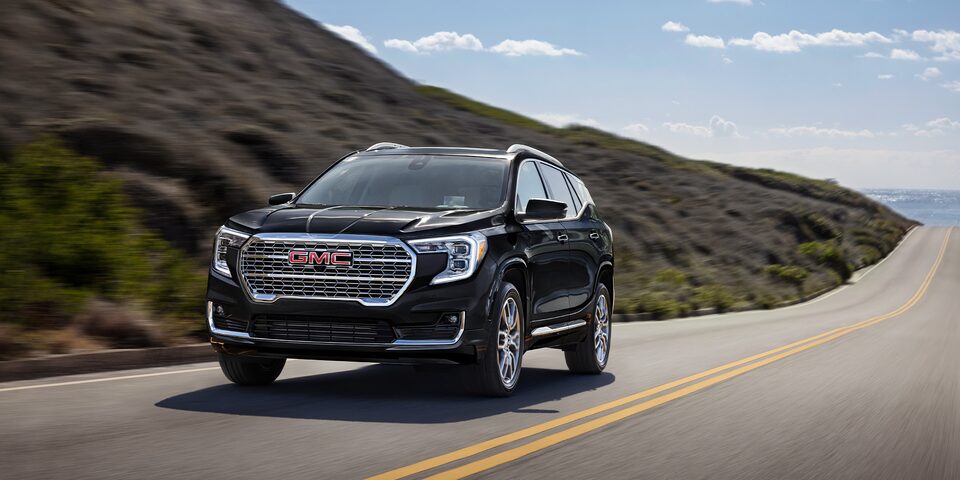 The 2024 GMC Terrain Denali descending down from a hill.