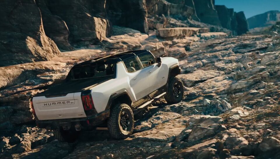 Driving the GMC Hummer EV on a rocky terrain.