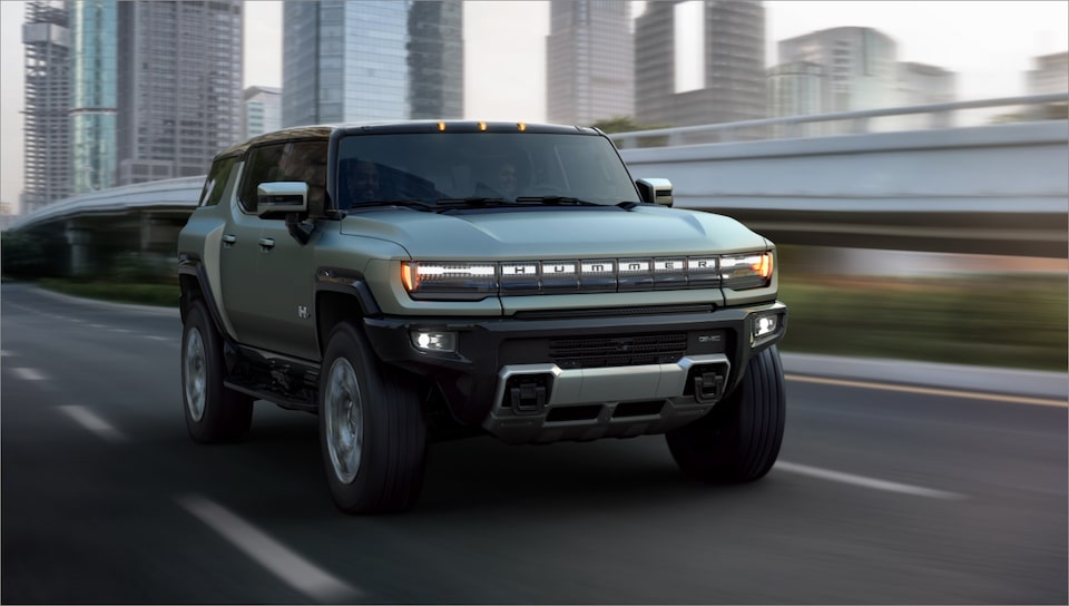 The Hummer EV SUV Speeding on an Open Expressway in the City.