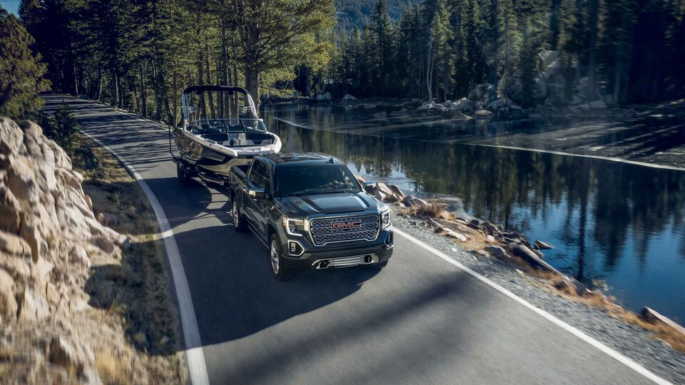 2022 GMC Sierra 1500 Denali driving on the road.