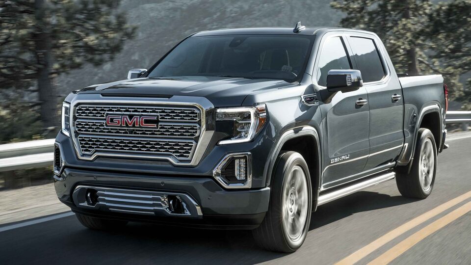 2022 Sierra 1500 Denali driving on the road.