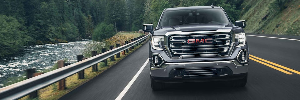 Front view of the 2022 GMC Sierra 1500 driving on the road.