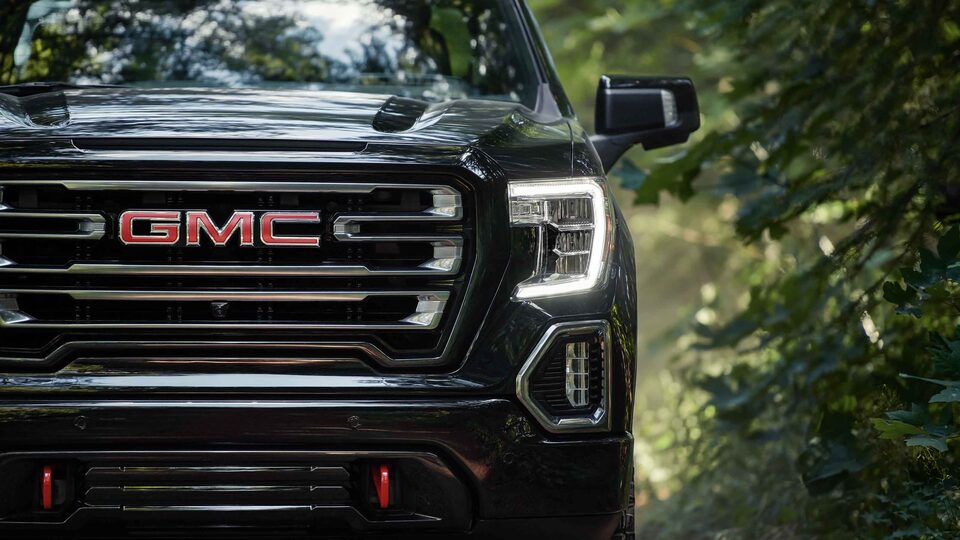 2022 GMC Sierra 1500 AT4 exterior featuring the headlights and grille.