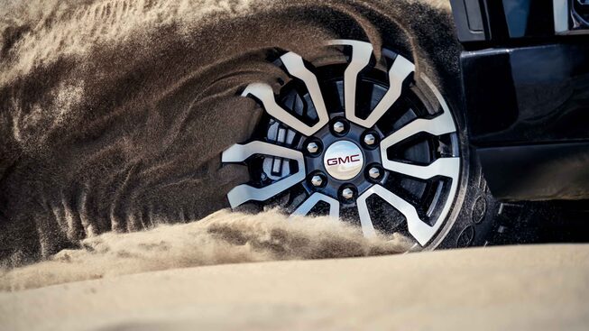 2022 Sierra AT4 wheel running through sand.