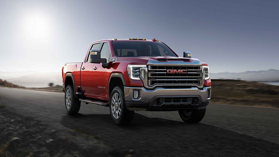 2022 GMC Sierra HD driving on the road.