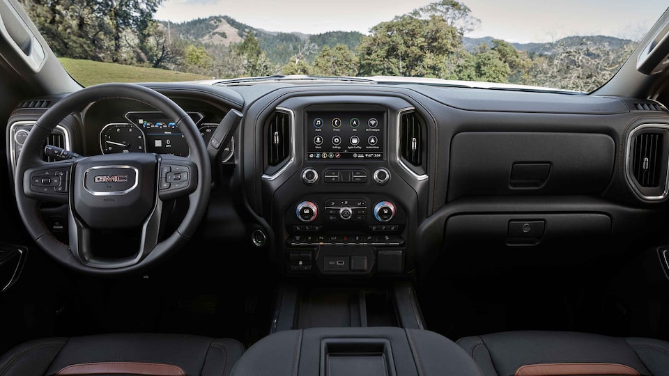 2022 Sierra HD AT4 athletic interior dashboard featuring the steering wheel and infotainment system.