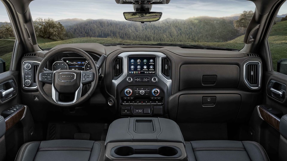 2022 Sierra HD Denali premium interior dashboard featuring the steering wheel and infotainment system.