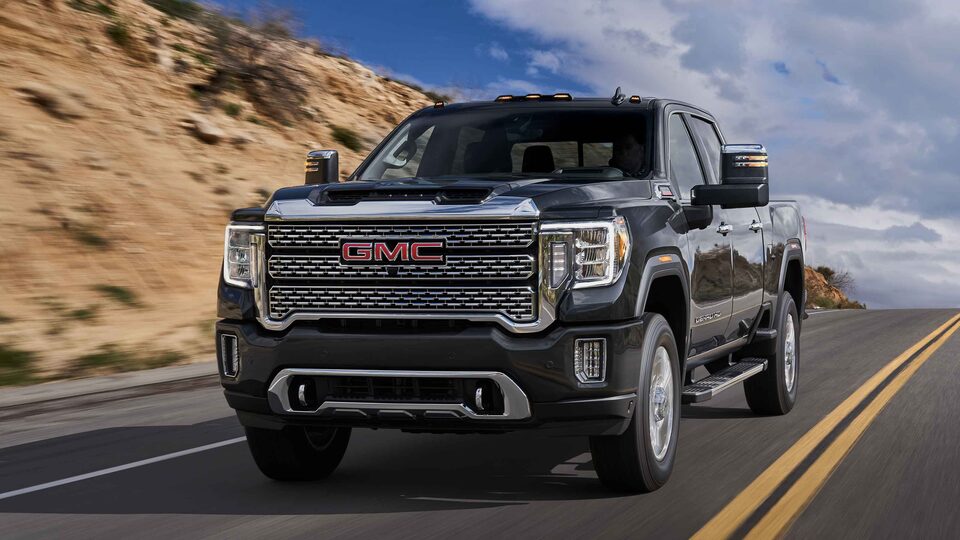 2022 GMC Sierra HD Denali driving on the road.