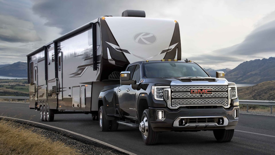 2022 GMC Sierra HD Denali towing and driving on the road.