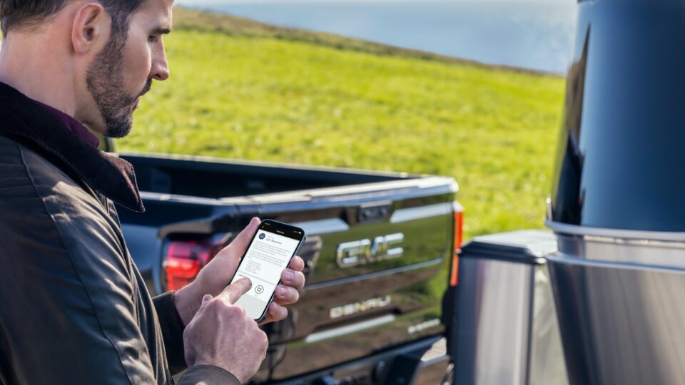 2022 Sierra 1500 Denali with person on myGMC mobile app.