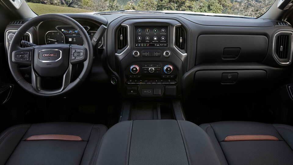 2023 Sierra HD AT4 athletic interior dashboard featuring the steering wheel and infotainment system.