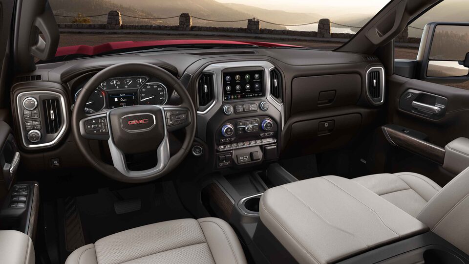 2023 Sierra HD interior featuring the dashboard, center console, and steering wheel.