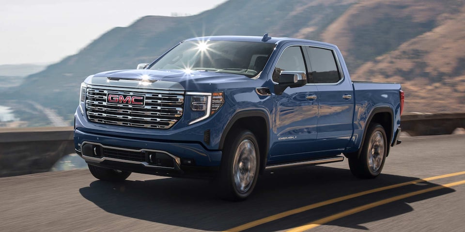 2025 GMC Sierra Denali Luxury Pickup Truck Driving Down a Winding Mountain Road