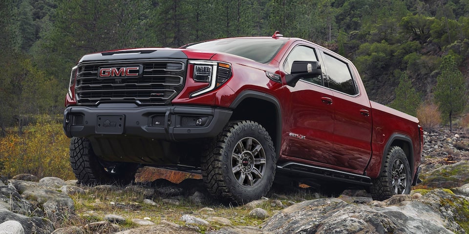 Front profile view of the 2025 Sierra 1500 on rocky terrain.