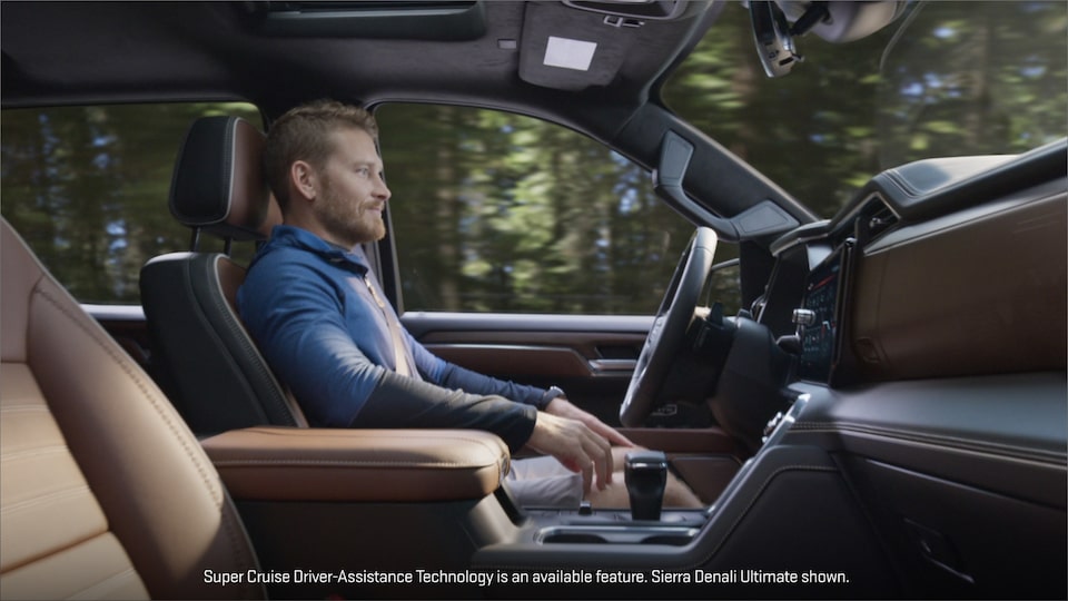 Side view of a Man Driving Using the Super Cruise Hands-Free Driving Assistance Technology.