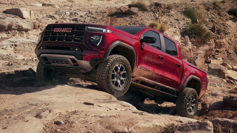 Front profile view of the 2023 GMC Canyon AT4X driving uphill.