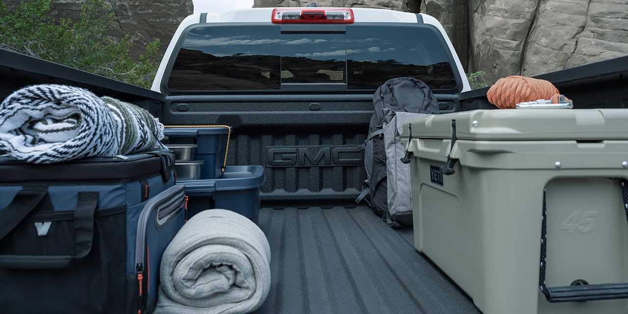 Bags and Crates stowed on the Cargo Bed of the 2026 GMC Canyon Elevation.
