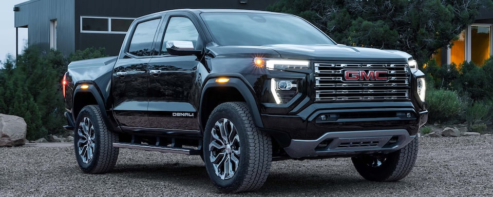 2024 GMC Canyon Denali luxury pickup truck parked outside.