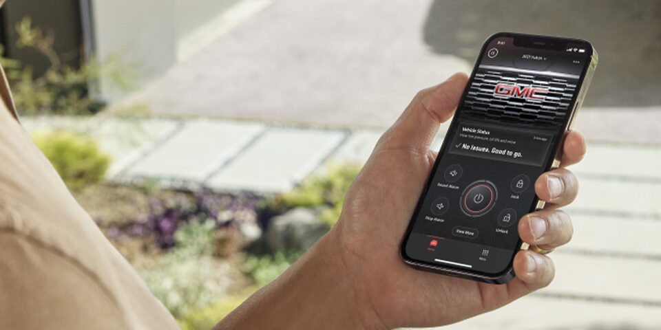 A person availing of the Remote Access Plan of the myGMC Mobile App on his phone.