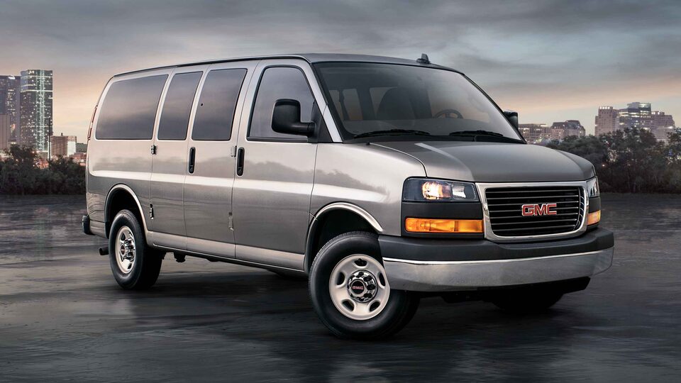 2023 Savana Passenger with a city sky line featuring Solar-Ray Deep-Tinted Glass.