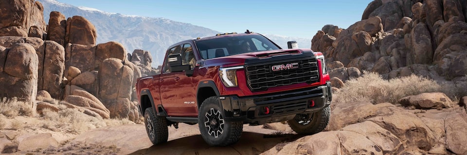 Front view of the 2025 GMC Sierra HD AT4X driving off-road.