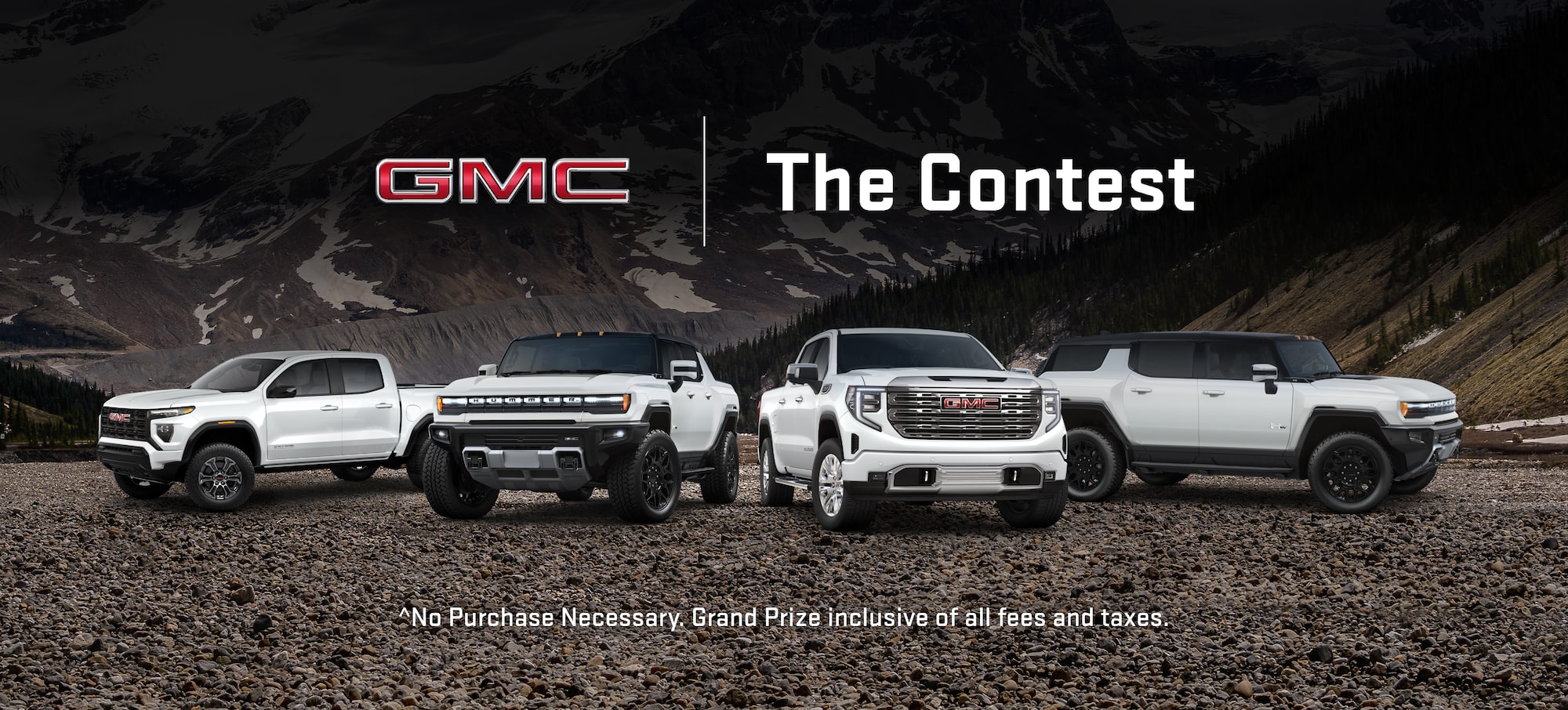 Four GMC vehicles parked in a mountain backdrop.