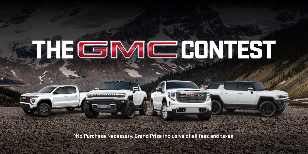 Four GMC vehicles parked in a mountain backdrop.