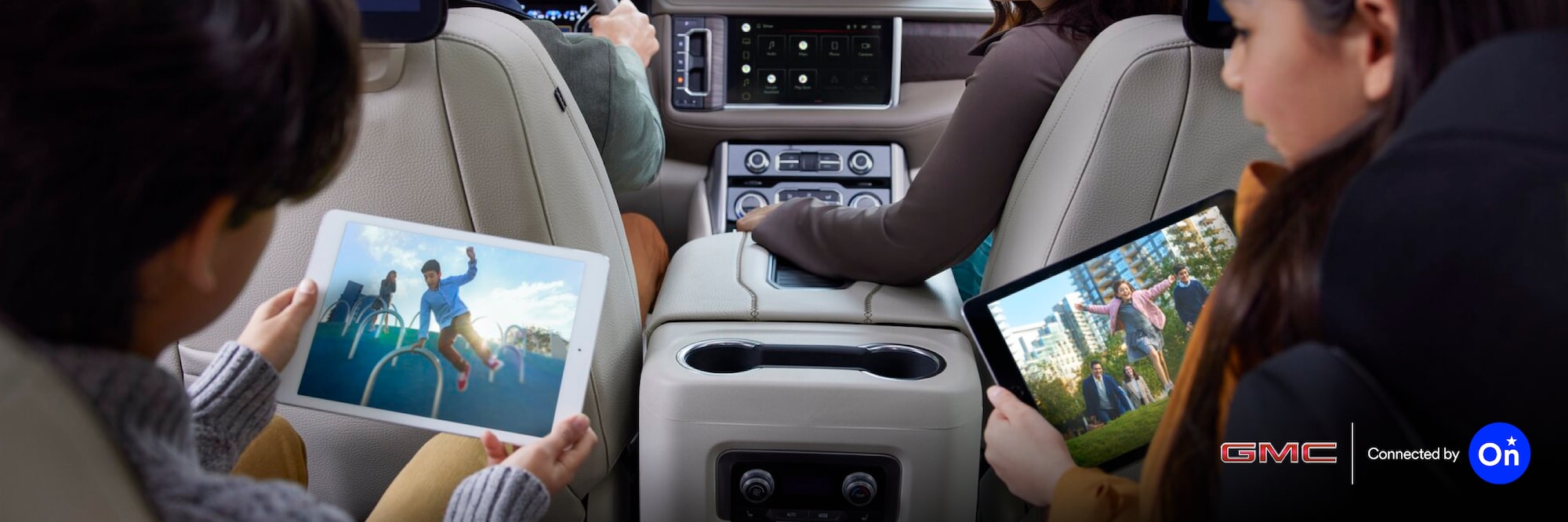 A family of four seated inside an OnStar-subscribed GMC vehicle.