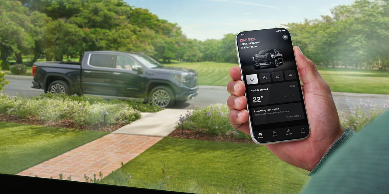Overhead View of a Person Sitting in a Car while using the myGMC Mobile App.