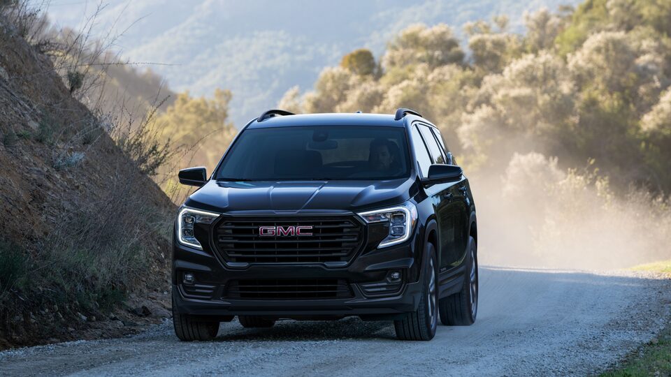 2022 Terrain SLE/SLT Elevation Trim driving on a dusty road.
