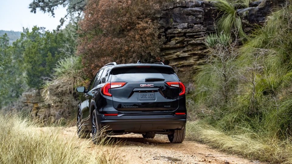 Back view of the 2022 Terrain SLE/SLT Elevation Trim driving off-road.