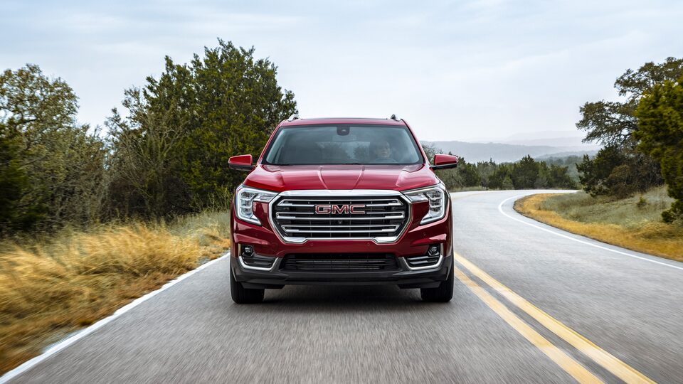Front view of the 2022 Terrain SLE/SLT driving on the road.