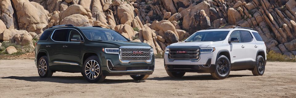 2023 Acadia Denali and AT4 parked outdoors.