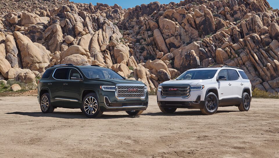 2023 Acadia Denali and AT4 parked outdoors.