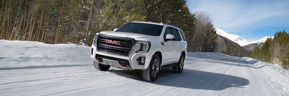 2023 Yukon AT4 driving on the road.