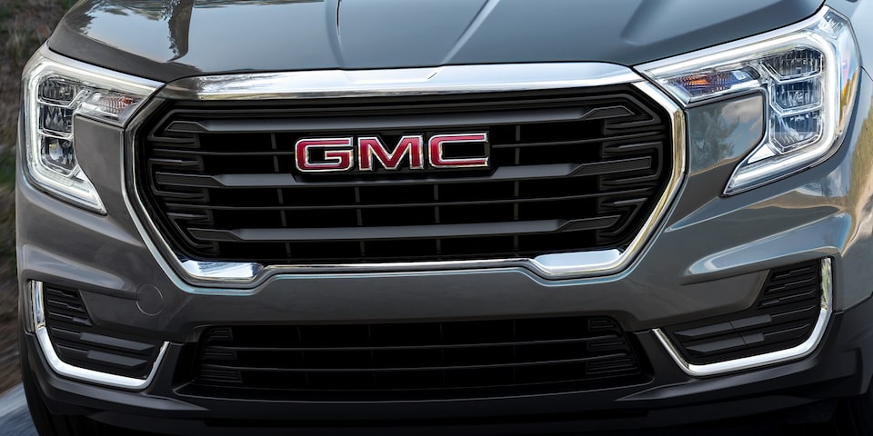 Front view of the 2024 GMC Terrain while driving on the road.